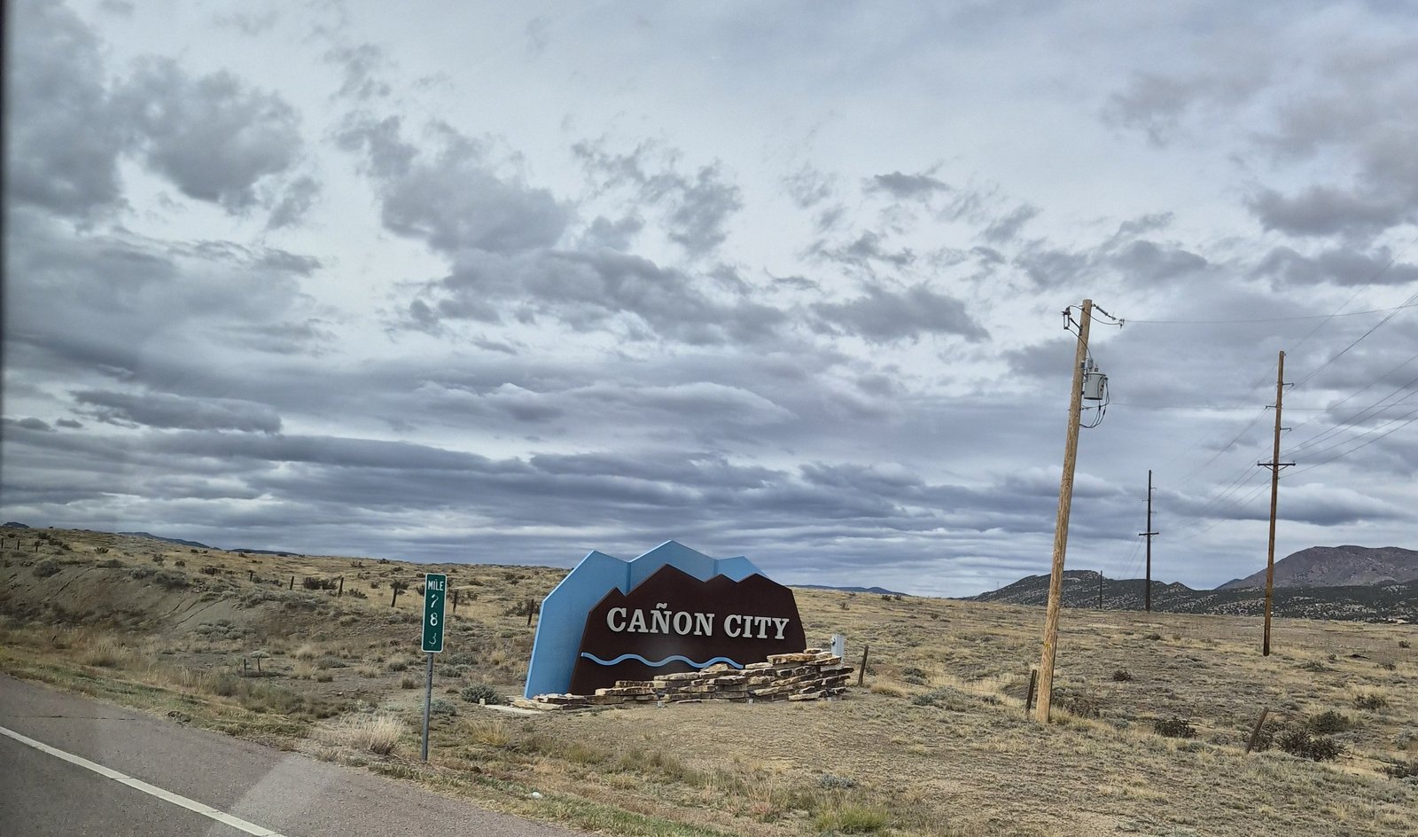Cañon City sign under wild clouds